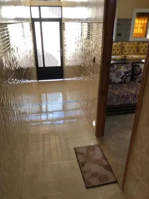 a reflection of a living room with a glass wall at Mahmoud moulay Yacoub 1 in Moulay Yacoub