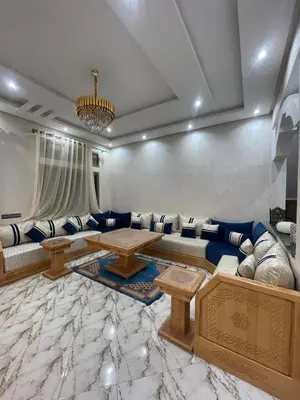 a living room with a couch and a table at Villas Près De Chez Vous in Amezrou