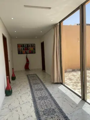 a living room with a large window and a rug at Villas Près De Chez Vous in Amezrou