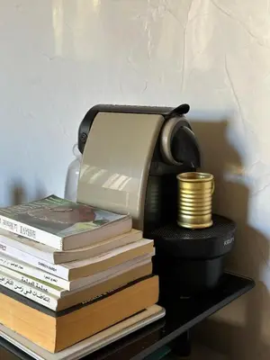 a telephone sitting on top of a stack of books at Fez Room in Fès