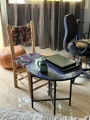 a table and two chairs with a laptop on it at Fez Room in Fès