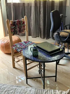 a room with two chairs and a table with a laptop at Fez Room in Fès