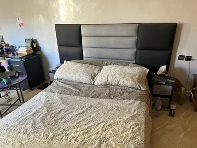 a bedroom with a large bed with a large headboard at Fez Room in Fès