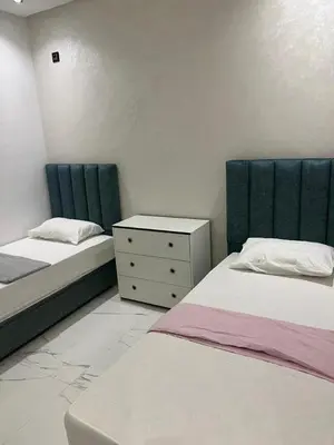 a bedroom with two beds and a dresser in it at Appartement la Cañada in Ville Nouvelle