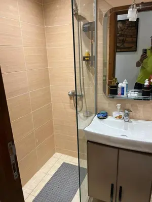 a bathroom with a shower and a sink and a mirror at Appartement la Cañada in Ville Nouvelle