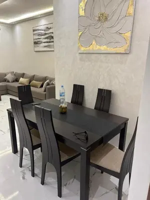 a black dining room table with chairs and a bottle of water at Appartement la Cañada in Ville Nouvelle