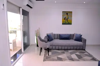 a living room with a couch and a chair at Appartement duplex très chic in Ville Nouvelle