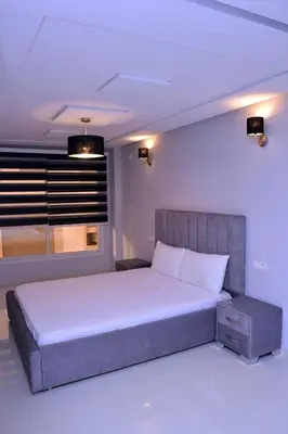 a bedroom with a large bed and a window at Appartement duplex très chic in Ville Nouvelle