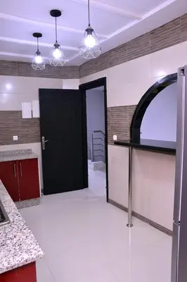a kitchen with a black door in a room at Appartement duplex très chic in Ville Nouvelle
