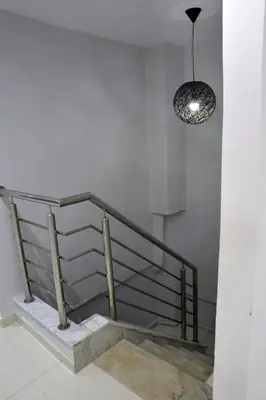 a staircase with a pendant light in a building at Appartement duplex très chic in Ville Nouvelle