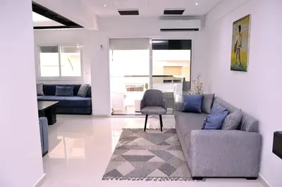 a living room with a couch and a chair at Appartement duplex très chic in Ville Nouvelle