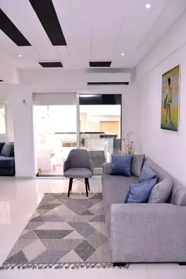 a living room with two couches and a chair at Appartement duplex très chic in Ville Nouvelle