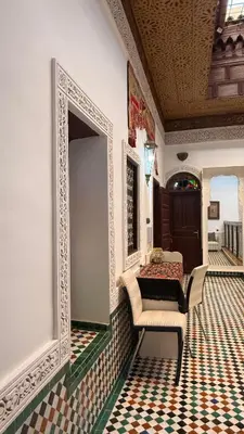 a room with a mirror and chairs in a room at Riad d'Art de Fès in Fès al Bali
