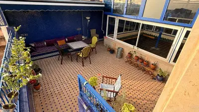 an aerial view of a balcony with a couch and chairs at Riad d'Art de Fès in Fès al Bali