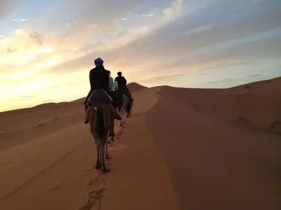 two people riding horses in the desert at Khamlia Desert Bed & Breakfast in Khamliya