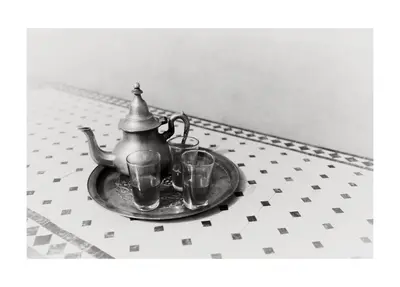a tea kettle and two glasses on a plate at Khamlia Desert Bed & Breakfast in Khamliya
