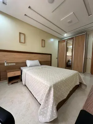 a bedroom with a large bed with a white comforter at appartement à fes in Fès