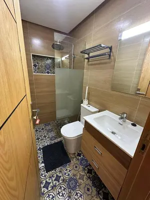 a bathroom with a white toilet and a sink at appartement à fes in Fès