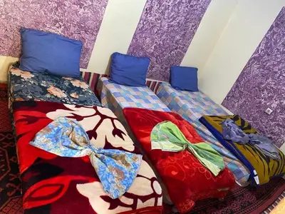 two beds sitting next to each other in a room at Taghia Accommodation in Taghia