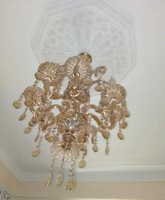 a gold chandelier hanging from a ceiling at Appartement lala Houriya fez in Fès