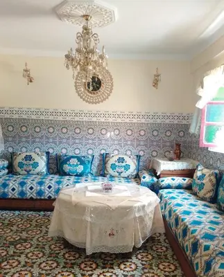 a living room with a couch and a chandelier at Appartement lala Houriya fez in Fès