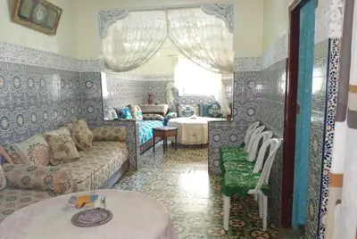 a living room with a couch and a table at Appartement lala Houriya fez in Fès