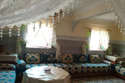 a living room with a couch and two windows at Appartement lala Houriya fez in Fès
