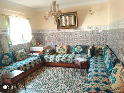 a living room with a couch and a table at Appartement lala Houriya fez in Fès