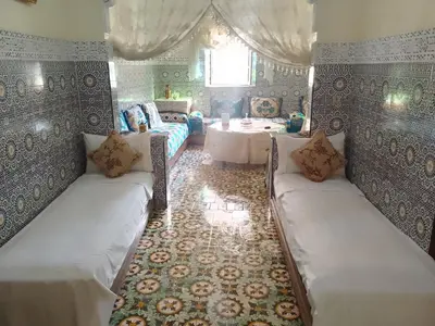 a living room with two couches and a table at Appartement lala Houriya fez in Fès