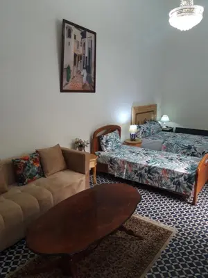 a living room with a couch and a coffee table at Chambres d'Hôtes Hayat in Dar Mahres