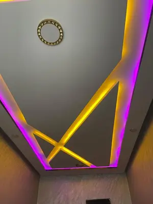 a room with purple and yellow lights on the ceiling at Logement bien placé in Meknès