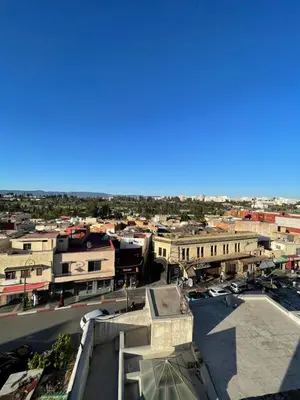 an aerial view of a city with buildings at Logement bien placé in Meknès