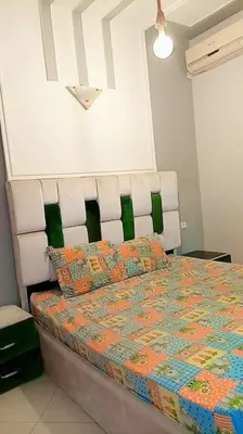 a bedroom with a bed with a quilt and pillows at شقة بموقع جد مناسب فاس in Fès