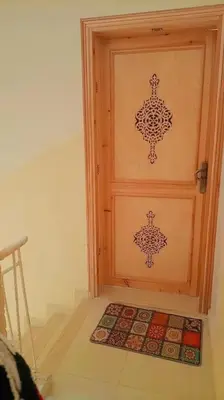 a door with a design on it in a room at شقة بموقع جد مناسب فاس in Fès