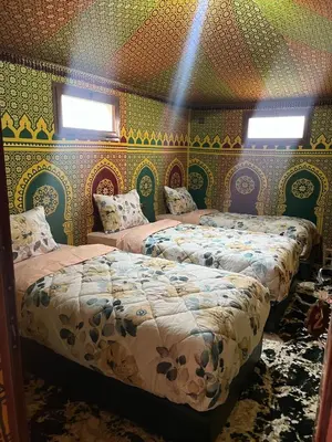 a bedroom with two beds in a room at Villa Maroua in Madkhal Meski