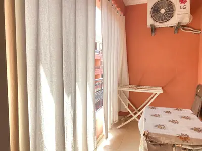 a room with a window with curtains and a table at Mahdi Oussama in Tazelaft
