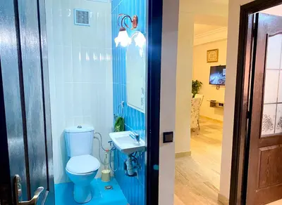 a blue bathroom with a toilet and a sink at Mahdi Oussama in Tazelaft
