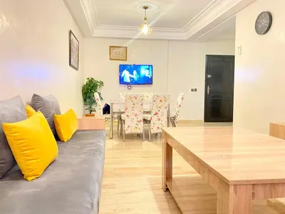 a living room with a couch and a table at Mahdi Oussama in Tazelaft
