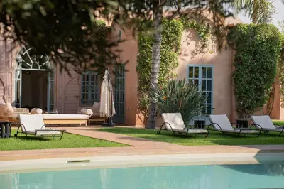 a pool with chairs and a table and a building at Villa Blisina - Piscine privée & Petit-déjeuner inclus à Marrakech in Marrakech