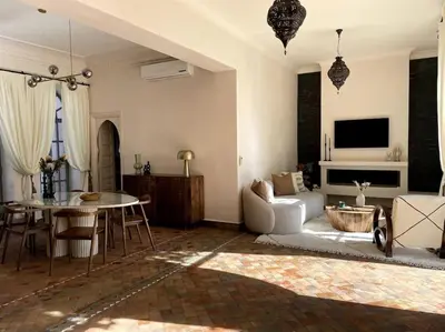 a living room with a couch and a table at Villa Blisina - Piscine privée & Petit-déjeuner inclus à Marrakech in Marrakech