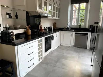 a large kitchen with white cabinets and appliances at Villa Blisina - Piscine privée & Petit-déjeuner inclus à Marrakech in Marrakech