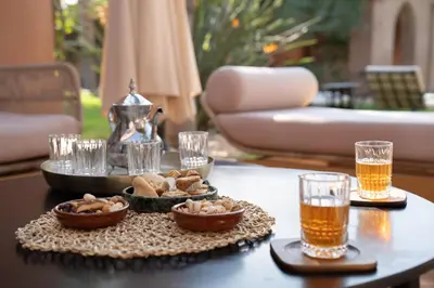 a table with a tray of food and two glasses of beer at Villa Blisina - Piscine privée & Petit-déjeuner inclus à Marrakech in Marrakech