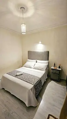 a bedroom with a large bed in a room at Maison Ali in Ville Nouvelle