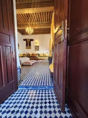 a hallway with a room with a checkerboard floor at Dar Zerbtana suite privative in Fès al Bali