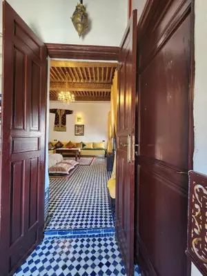 a hallway of a house with a room with a couch at Dar Zerbtana suite privative in Fès al Bali