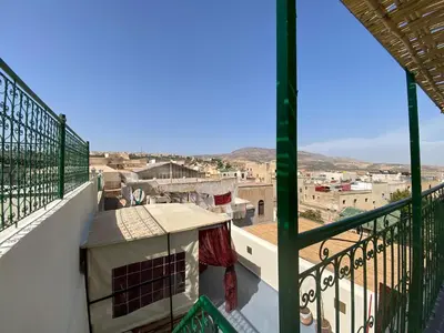 a balcony with a view of a city at Dar Zerbtana suite privative in Fès al Bali