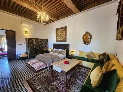 a living room with a bed and a couch at Dar Zerbtana suite privative in Fès al Bali