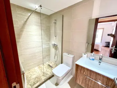 a bathroom with a shower and a toilet and a sink at Appartement luxueux Prestigia Wifi Fibre Optique in Fès