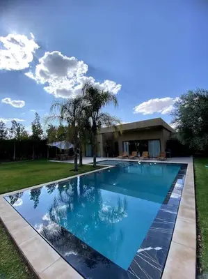 a large swimming pool in front of a house at Villa P1 avec Piscine Chauffée in Marrakech