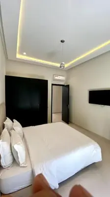 a bedroom with a bed with white sheets and pillows at Villa P1 avec Piscine Chauffée in Marrakech